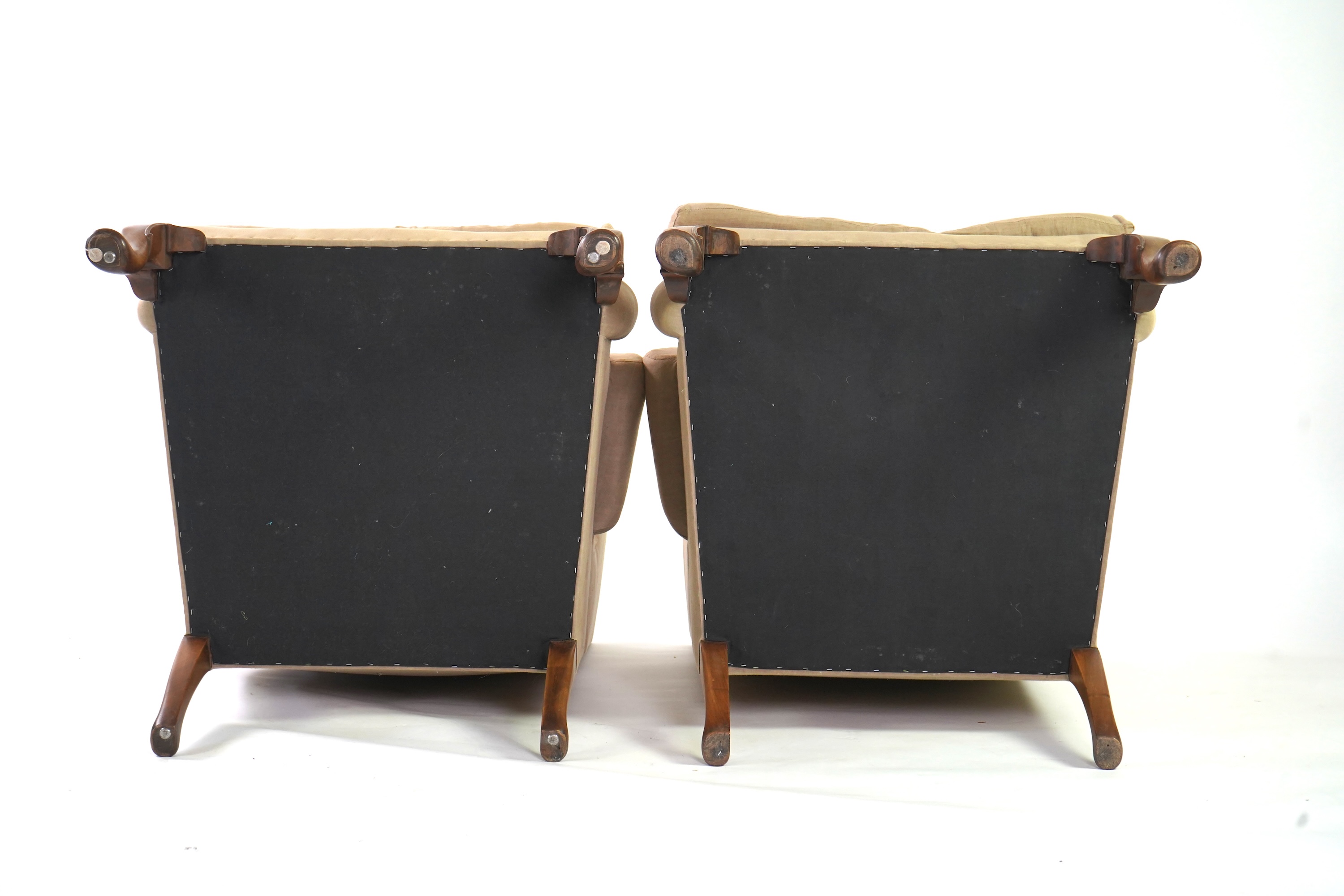 A pair of late 19th / early 20th century George II style upholstered wing armchairs